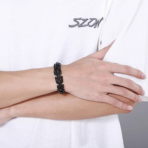 Close-up of a black dragon scale link bracelet in stainless steel on a male wrist