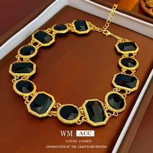 Vintage gold textured necklace with black faceted stones in an elegant 45-degree angle view