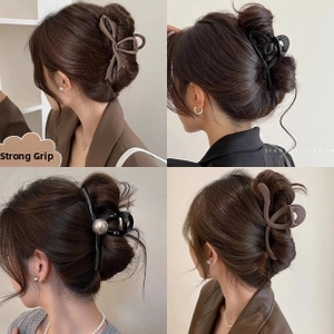 Detailed views of four elegant hair claw clips in brown, black, and pearl-embellished styles