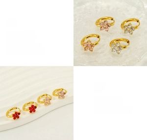 Close-up of gold-plated floral huggie hoop earrings with colorful zircon petals