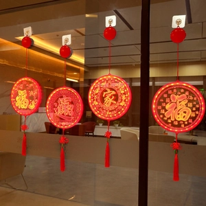 Detail of red LED window suction lights with Chinese knots and traditional tassels