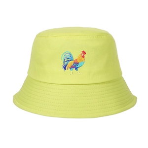 Close-up of rooster embroidery on a vibrant yellow-green cotton canvas bucket hat