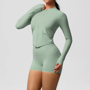 Detail of sage green yoga set with thumbhole sleeves and high waist fitness shorts