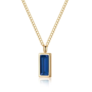 Detailed shot of rectangle gold necklace with blue zircon pendant on white background