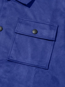 Detailed macro view of heavy suede jacket featuring flap pocket and black metal button