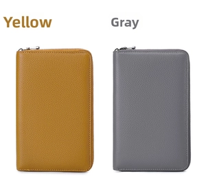 Detailed texture of yellow and gray pebble leather wallets with silver zippers