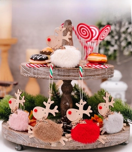 Detailed view of five colorful wooden reindeer plush ornaments for Christmas tree decor.
