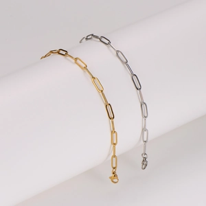 Elegant gold and silver stainless steel paperclip chain anklets on white display stand