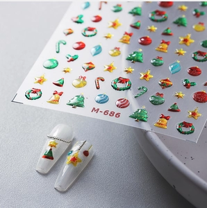 Macro view of Christmas nail art stickers M-686 featuring trees, bells and wreaths