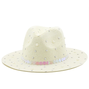Detail of straw sun hat with pearls, rhinestones and iridescent sequins decoration