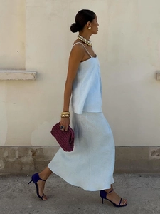 Outdoor shot showing the natural drape and movement of the blue linen blend skirt set