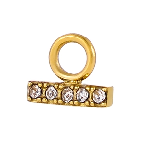 Macro detail of gold-plated rectangular pendant charm with five inlaid zircons