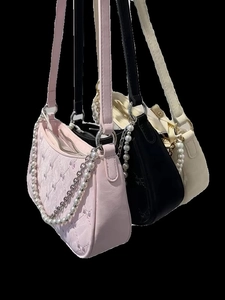 Pink, black, and white quilted bow shoulder bags with pearl and metal chain straps