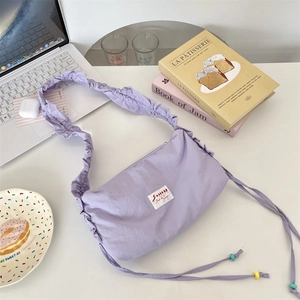 Detail of light purple pleated shoulder strap with colorful wooden bead drawstring accents