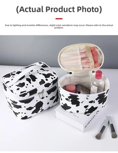 Detail of cow print makeup bag set with brush slots and large interior storage