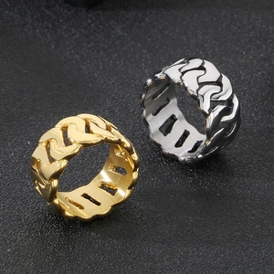 Macro shot of Cuban link chain rings in gold and silver finish with polished steel texture