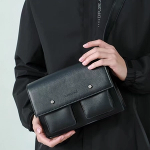 Modern black leather messenger bag with flap closure and dual front pockets for men