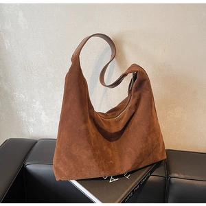 Brown suede tote bag with large capacity shown in a minimalist lifestyle setting