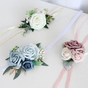 Elegant bridal wrist corsages with realistic roses, pearls and ribbons for weddings