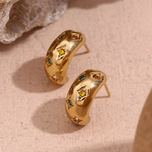 Detailed macro view of 18K gold-plated C-shaped earrings with colorful zircon star inlays