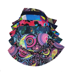 Detail view of assorted printed bucket hats featuring vibrant galaxy and bohemian patterns