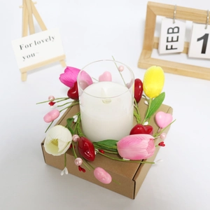 Tulip candle ring with red hearts and pink berries on a kraft paper gift box