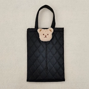 Detail of black quilted leather car tissue box cover with a cute plush bear head decor