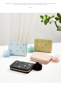 Mini zipper coin purses in four colors with heart patterns and fuzzy ball pendants