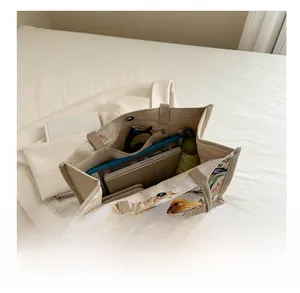 Spacious interior of linen tote bag showing magazines, umbrella, and sunglasses storage