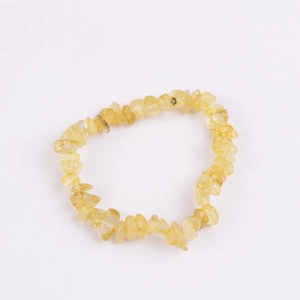 Detailed close-up of natural irregular yellow stone beads on a stretchy elastic bracelet