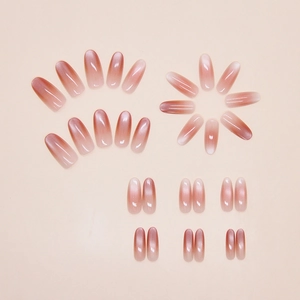 Detail of almond-shaped gradient cat-eye press-on nails in pink and reddish tones