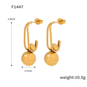 Detail showing titanium steel earrings with 1cm gold ball pendant and 3cm total length