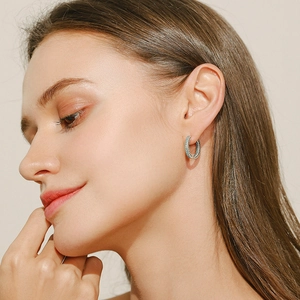 S925 sterling silver hoop earrings with hollow hearts and turquoise stones on model