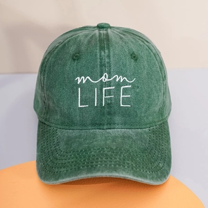 Close-up of mom LIFE white embroidery on vintage washed dark green cotton baseball cap