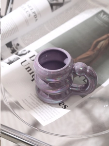 Detail of purple cloud shaped ceramic mug with a lustrous iridescent electroplated finish