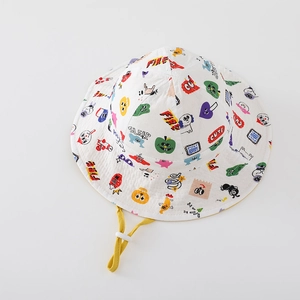 Detail of white cotton sun hat for kids featuring colorful cartoon prints and yellow cord