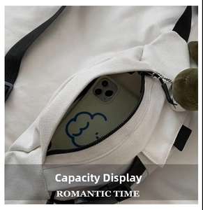 Detailed view of white canvas chest bag interior fitting a large smartphone
