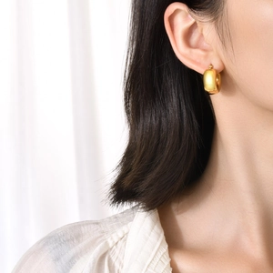 Minimalist gold hollow hoop earrings for women showing geometric circular design