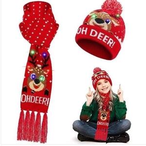 Detail showing the festive red LED knitted scarf with Oh Deer text and white tassels