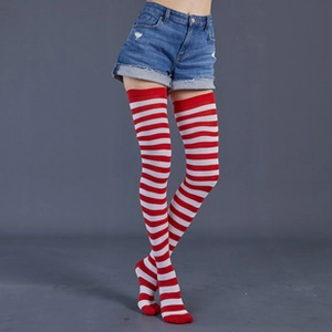 Detail of long red and white striped knit thigh high socks on a model