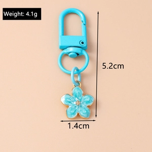 Blue flower keychain dimensions showing 5.2cm length and 1.4cm width on a khaki background