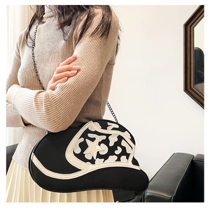 Detail of creative star pattern cow print hat-shaped shoulder bag with metal chain