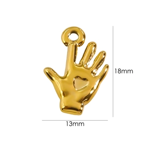 Detail of a 14K gold plated heart palm pendant with size markings 13mm and 18mm