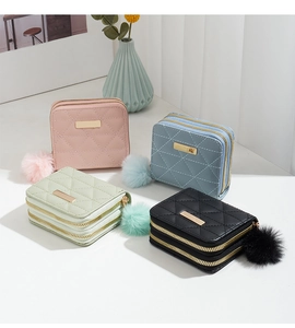 Quilted women's short wallets in four colors featuring dual zippers and plush fur ball charms