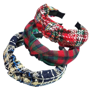 Close-up of three pieces knotted plaid headbands in red, green and navy tweed fabric