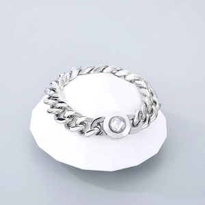 Polished silver 13mm Cuban chain bracelet with a central round crystal snap button accent