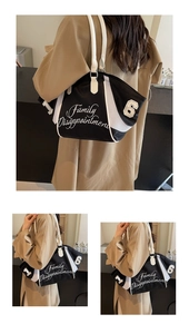 Detail of a large black and white bowling tote bag with embroidered letters on canvas