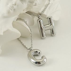 Puffy bubble alphabet necklaces with H and C pendants in polished stainless steel
