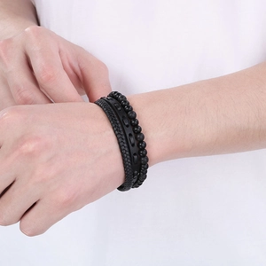 Close-up of men's multi-layer black leather bracelet with tiger eye beads and magnetic clasp