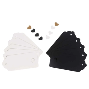 Detailed view of heart-shaped kraft paper gift tags in black and white colors